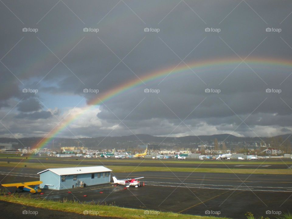 Raindrops make a double rainbow over the airport