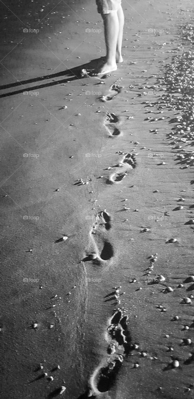 Footprints on the beach on a night walk