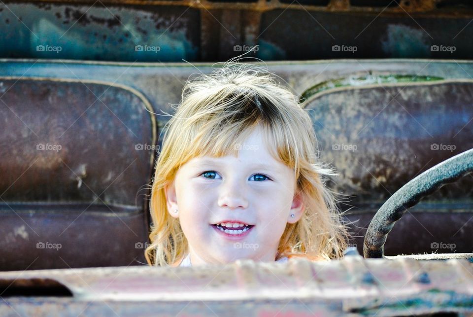 Child in antique car