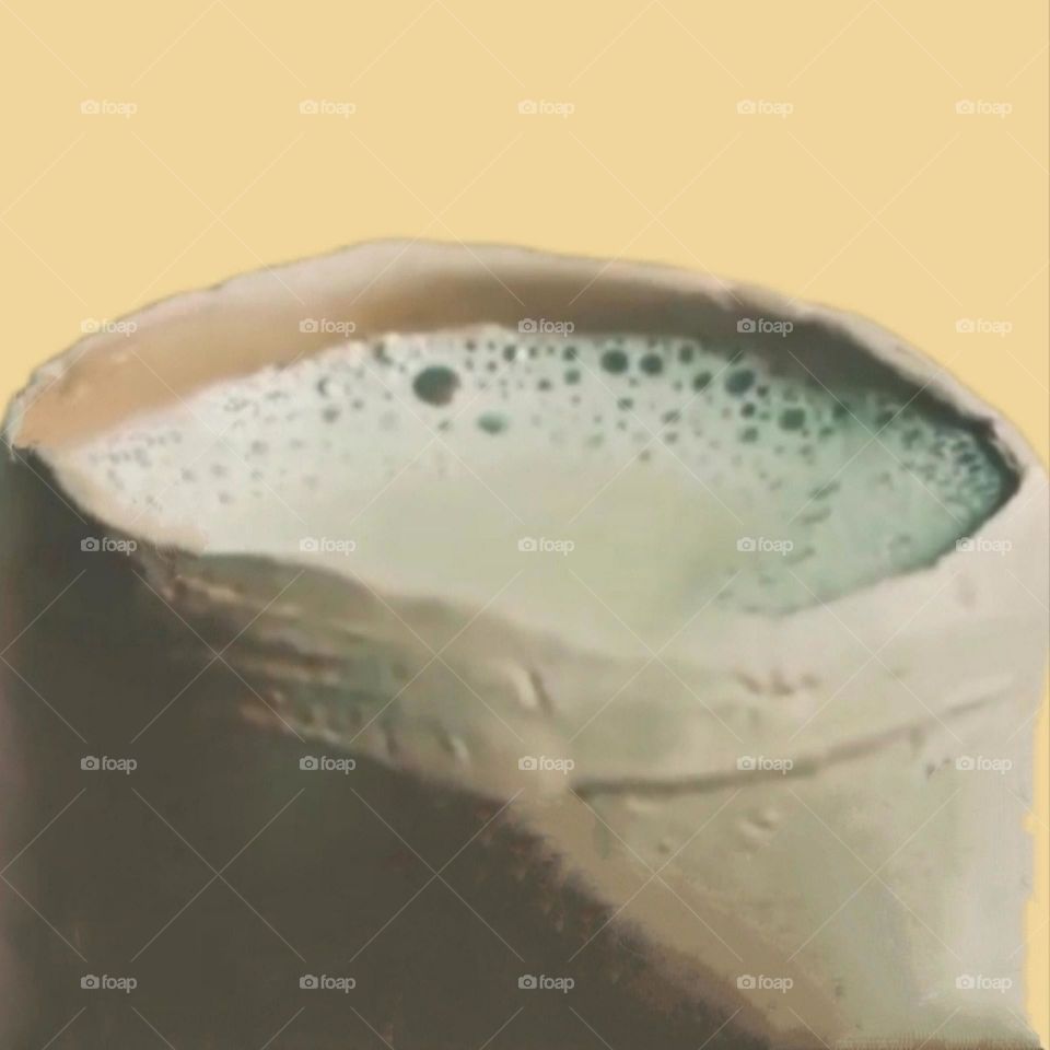 Drinking tea is being enjoyed in an earthen pot.