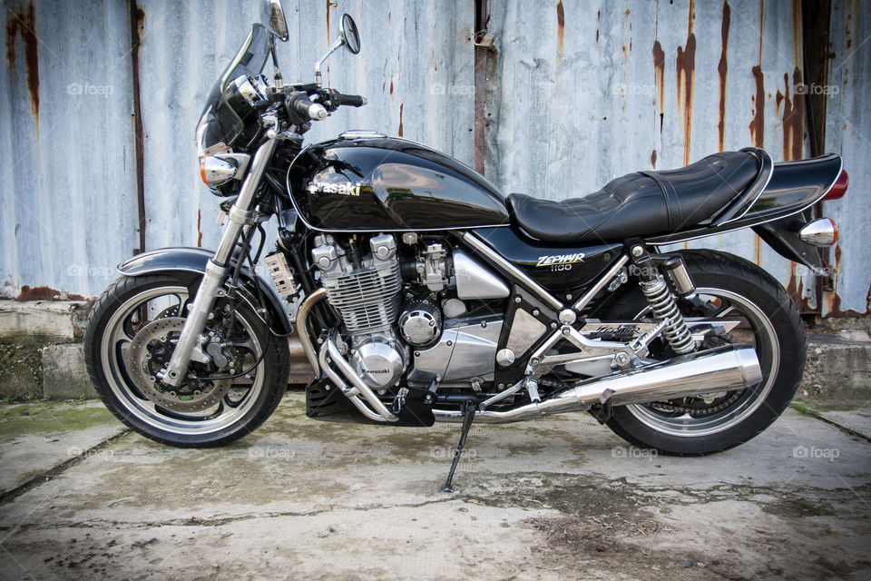 kawasaki zephyr motorcycle in front of the old rusty garage