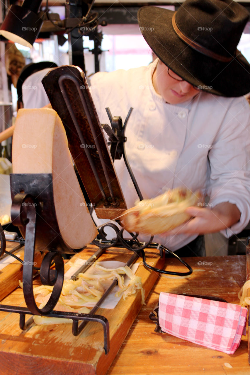 chef at work preparing a raclette,Paris