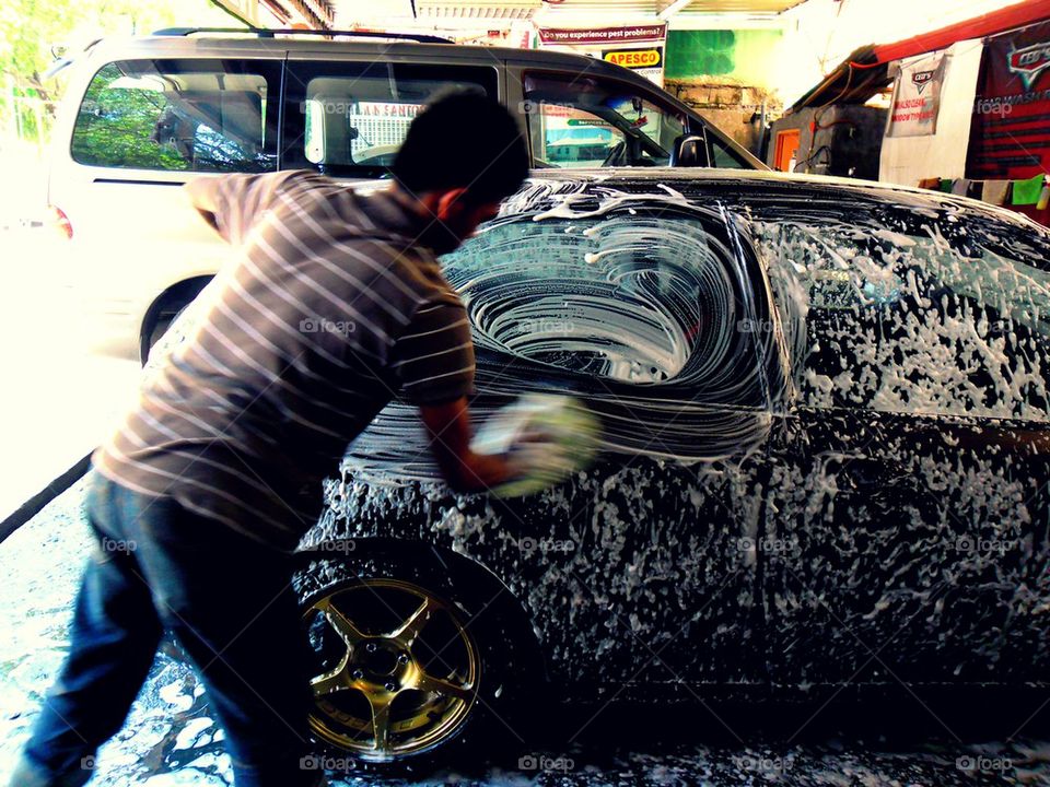 man washing a car