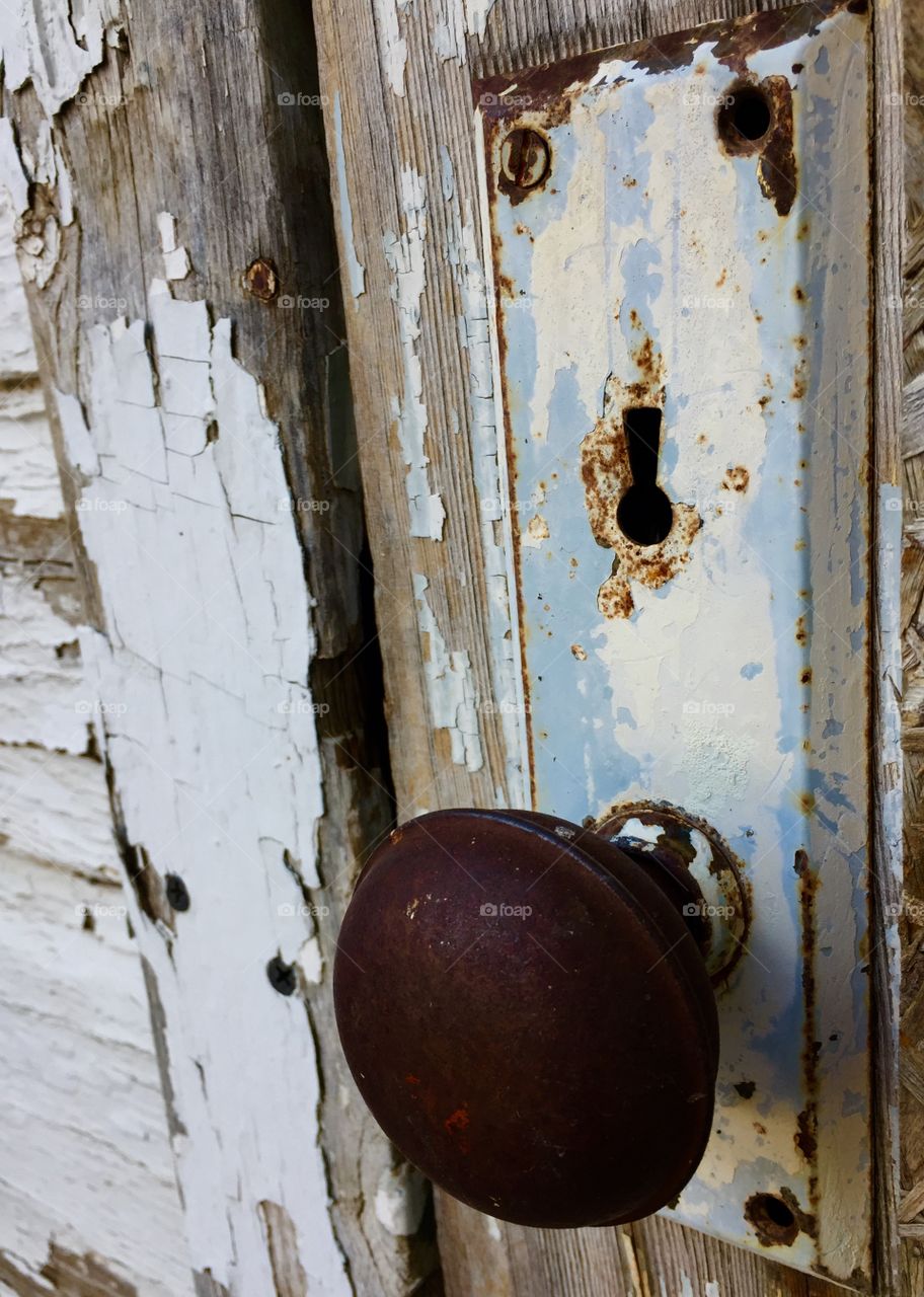 Antique door handle on abandoned door