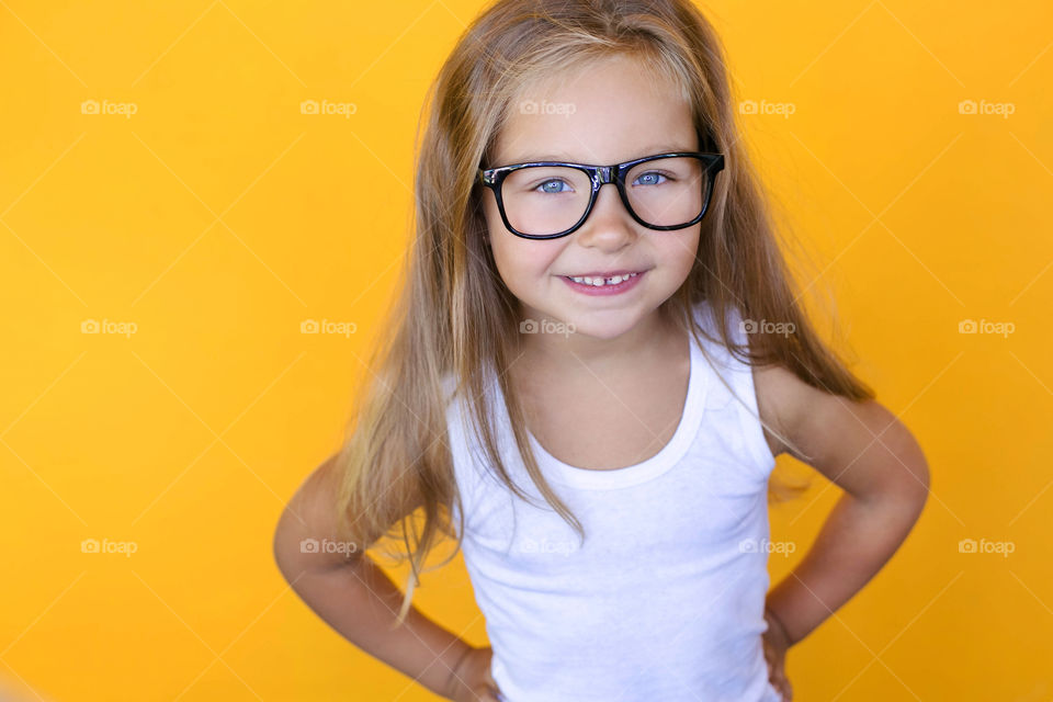 Cute girl with yellow background