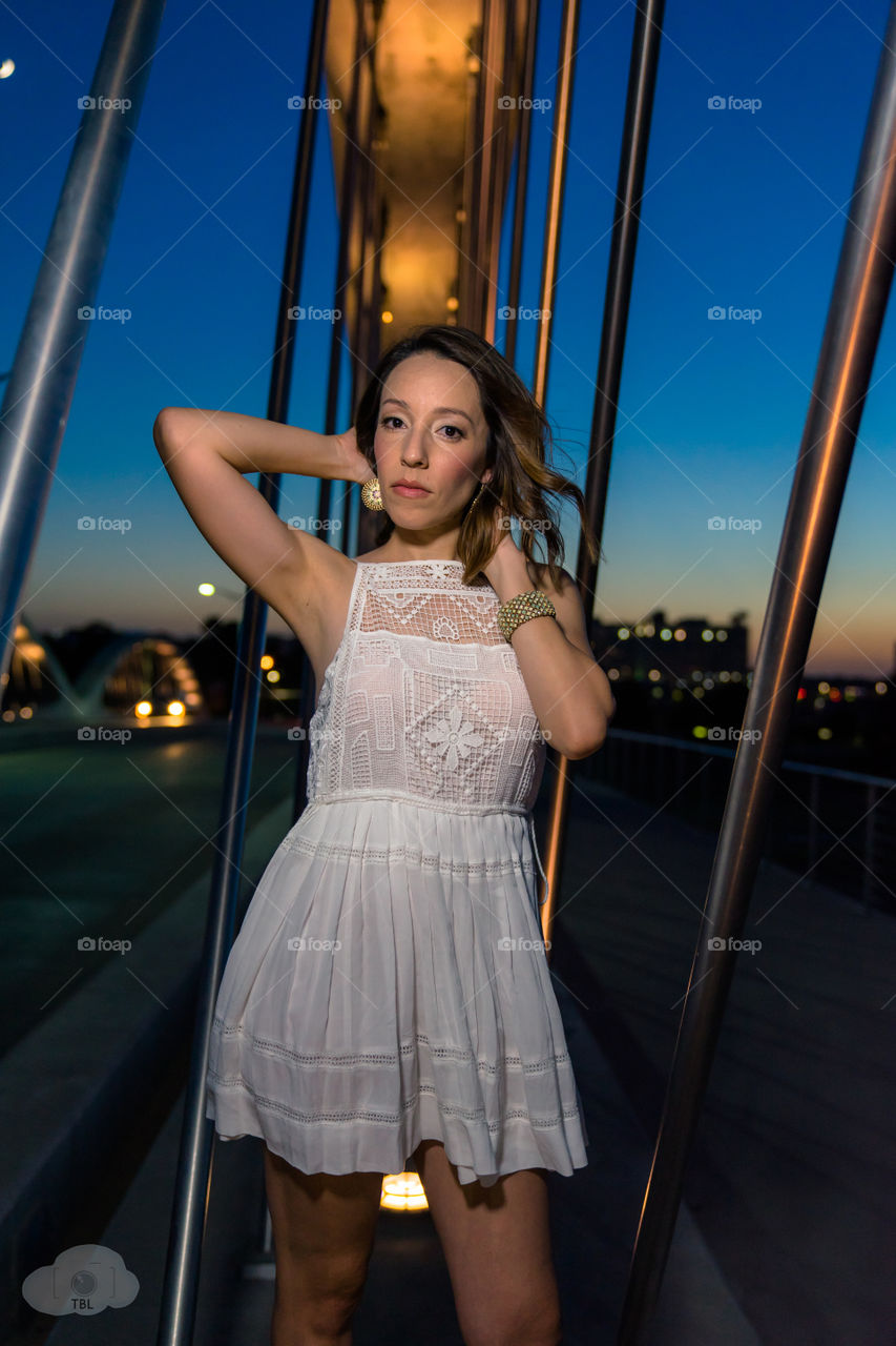 Beautiful woman posing in front of bridge
