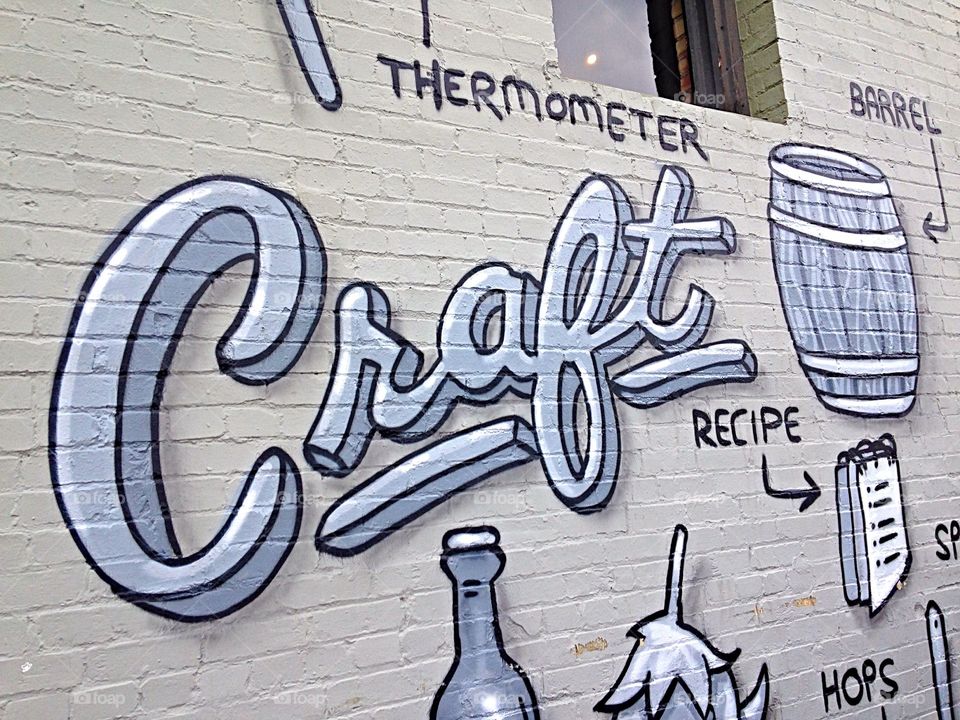 Craft beer . The story of craft beer on the outside wall of a brewery