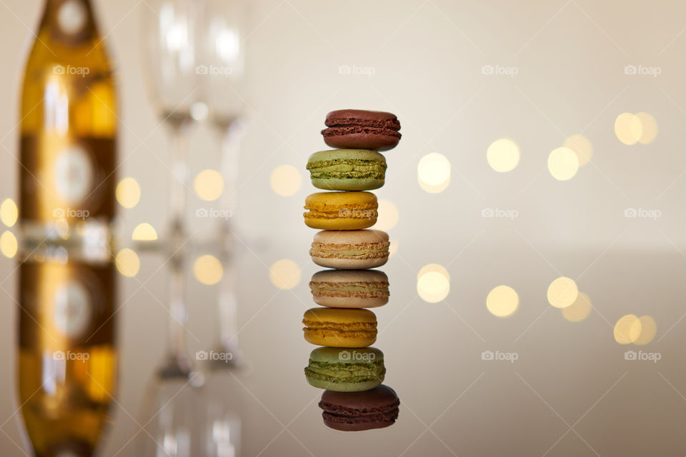 A stack of macarons on a reflective surface 