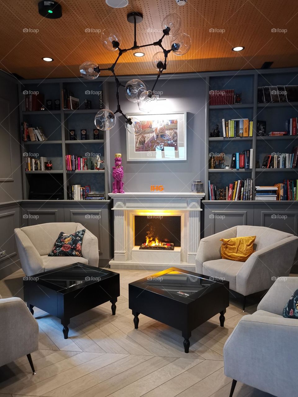 Interior design. The fireplace, bookshelves, armchairs. Rest corner.