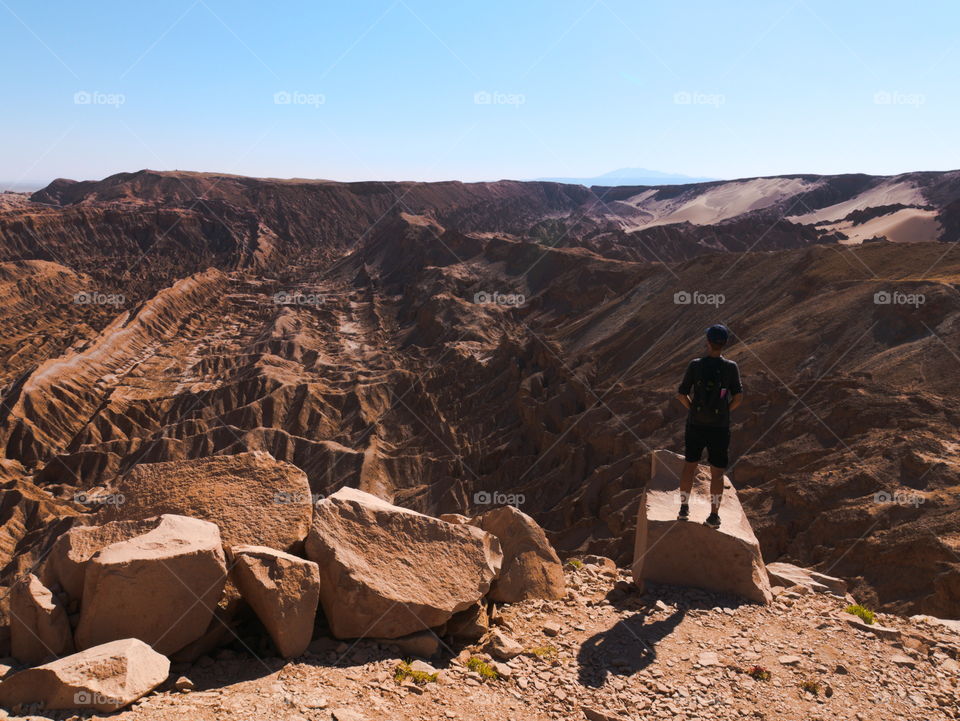 Man looking at the death valley in Atacama desert, Chile