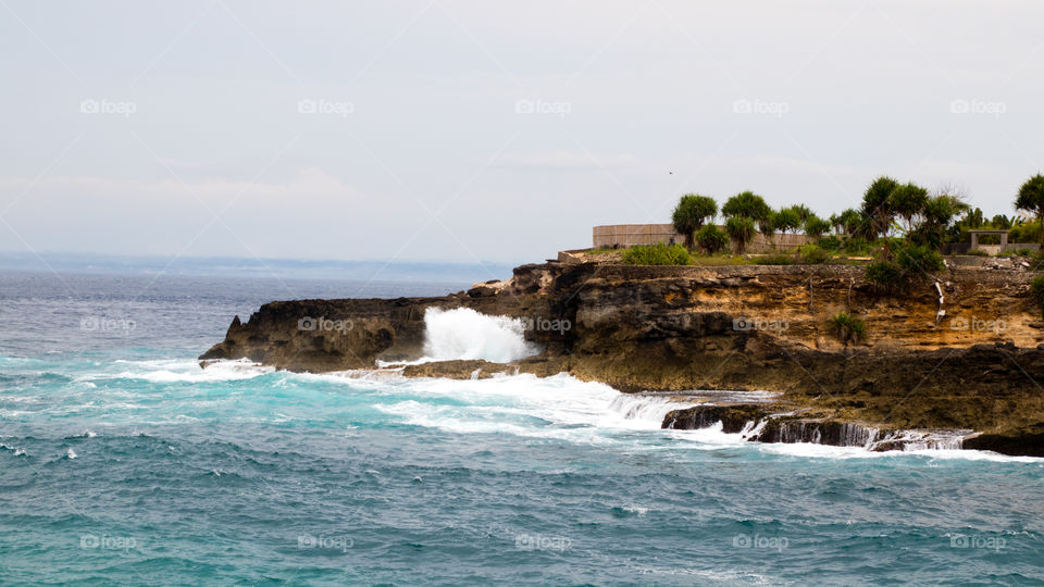 Waves banging against the rocky shoreline of southern Nusa Lembongan Indonesia