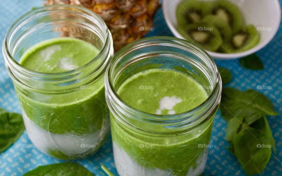 Fresh spinach kiwi and pineapple smoothie in jar