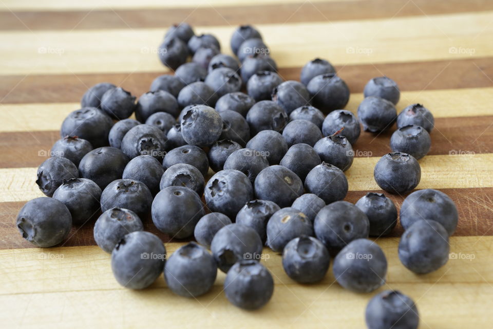 Blueberries on cutting board. 