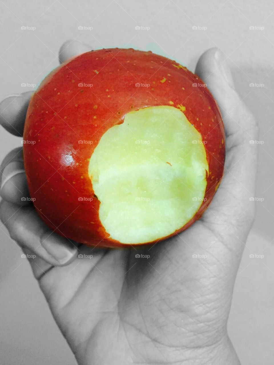 Holding a bitten apple