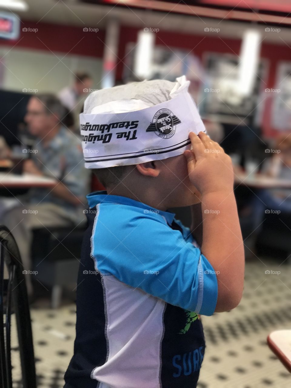 Little boy wearing paper cap