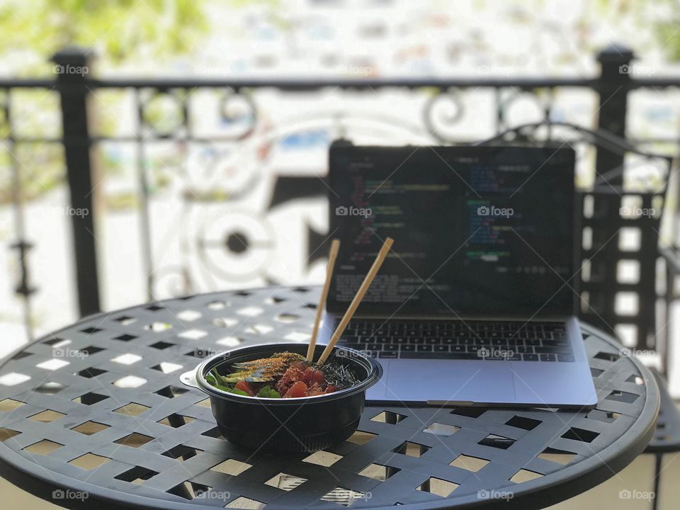 Munching sushi and coding on an Orlando rooftop balcony