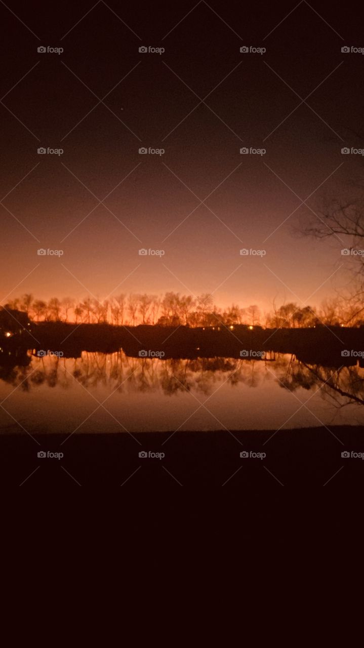 Night is near Silhouette, captivating, reflections, calm Conditions on Lake Water. Not a slight Ripple. 