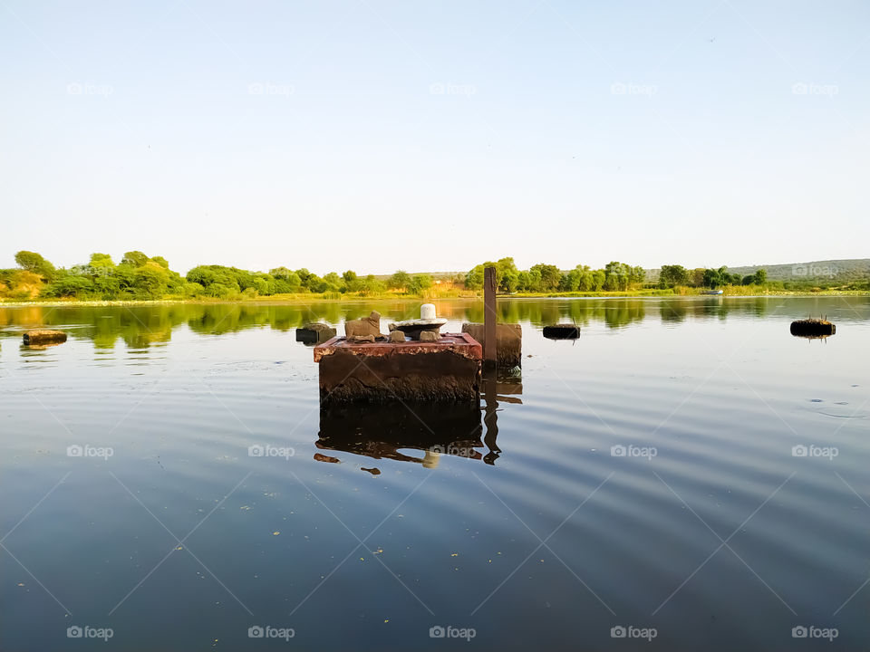 The idol of Lord Shiva inside the water of the river