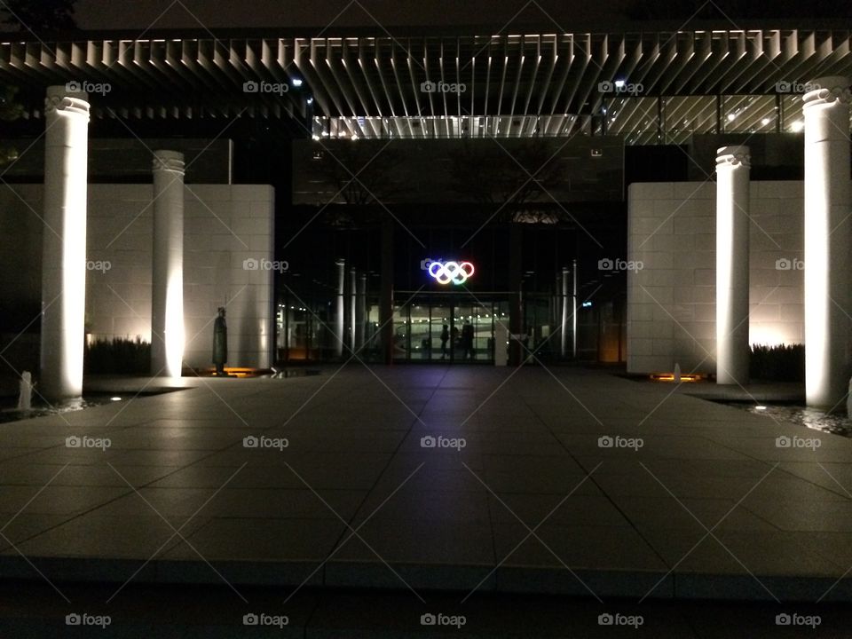 The Olympic Museum entrance at night with Olympic Rings 