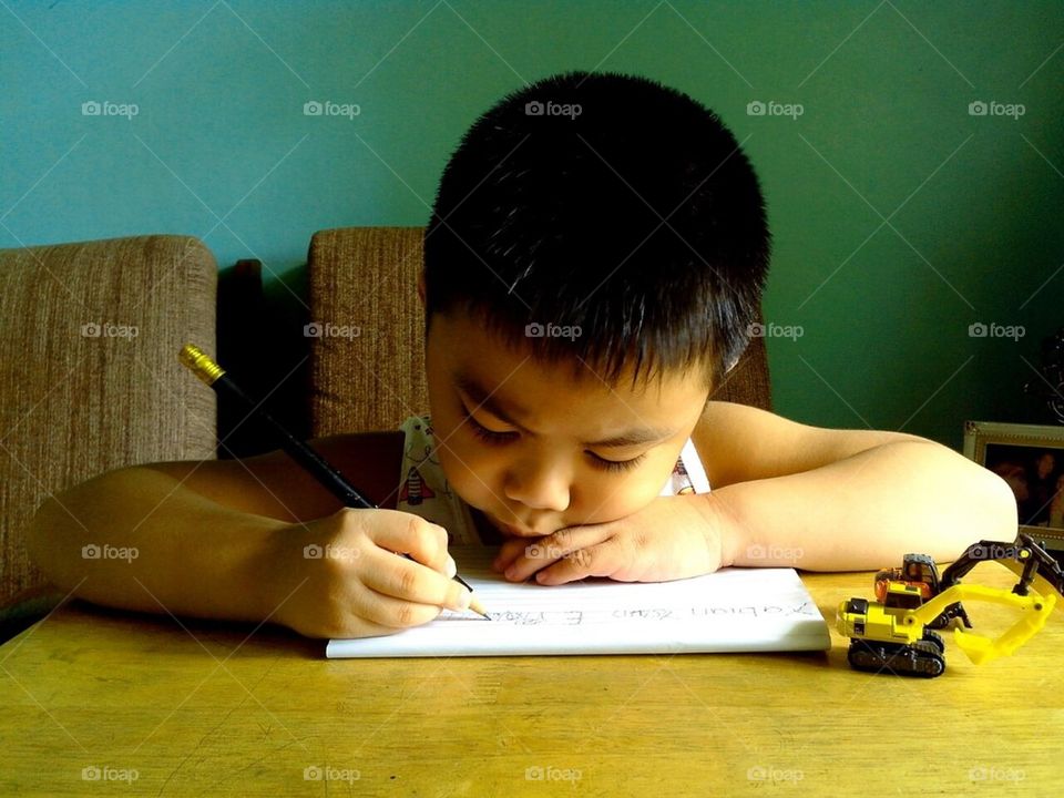 Little boy learning to write