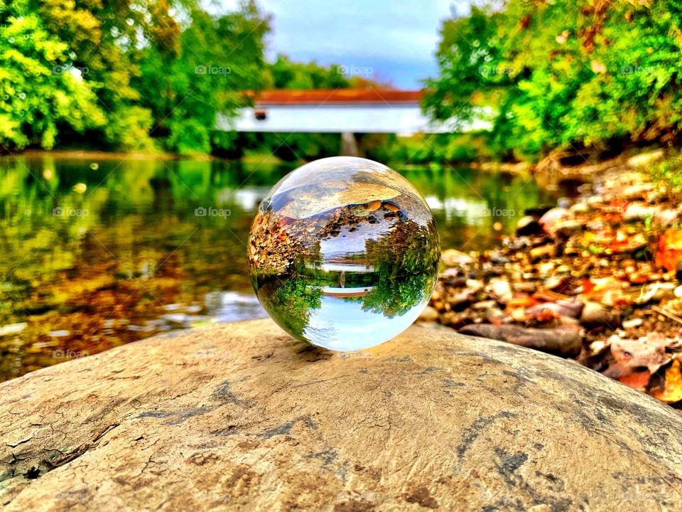 Covered bridge and a crystal ball on a fall day 