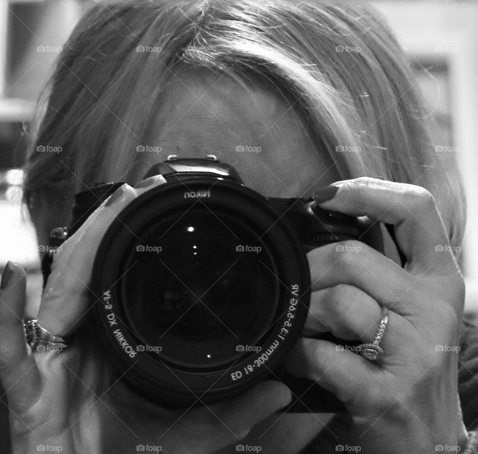 Woman looking throughout the lens of a camera 