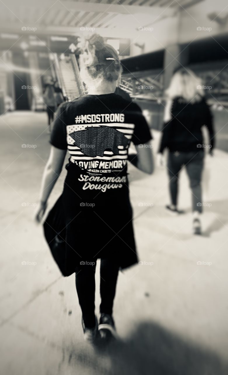A teenage girl wearing a T-shirt in memory of students killed in the mass shooting at Marjorie Stoneman Douglas High School on a day of youth protests against gun violence in the United States