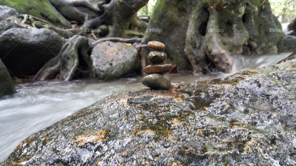 zen relaxing rock balance by the river in forest