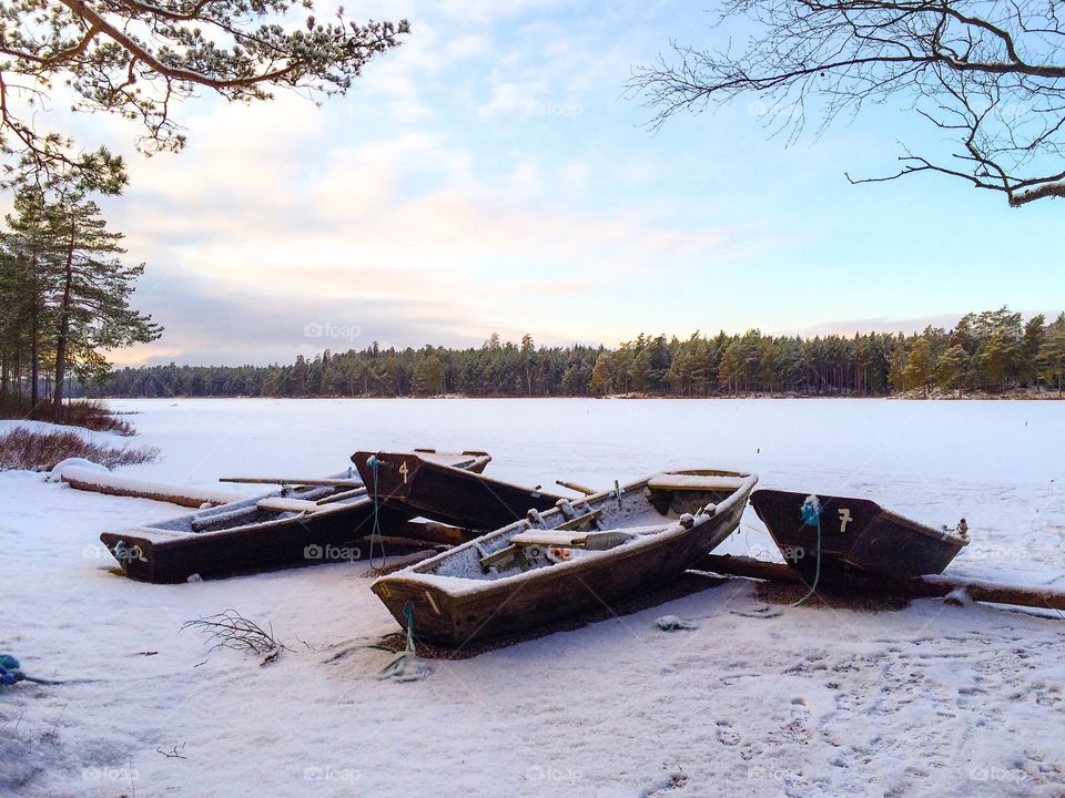 Boats on frozen lake