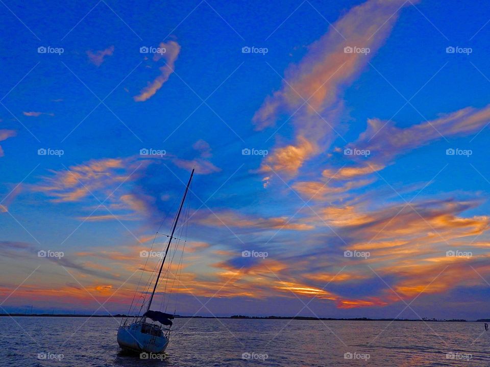 Color Explosion - Wispy colorful clouds during a descending sunset - Boldly and lexpressing myself through color since color is all around us in many different forms. Vibrant and varied mix of vibrant colors.