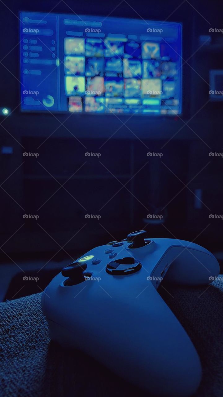 The Xbox controller glowing in front of the screen sets the perfect scene for those who live and breathe gaming. An image that embodies immersion, technology, and entertainment.