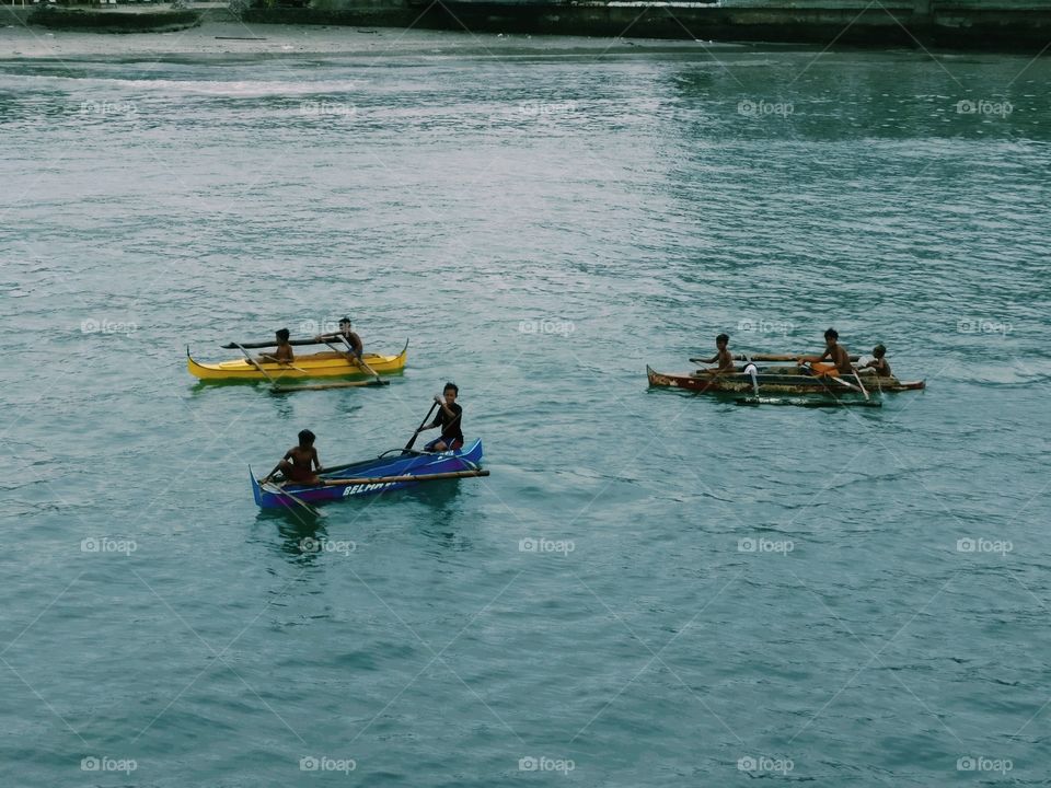 Indigenous children asking for coins near a seaport.