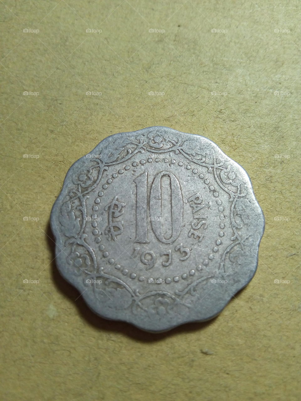 A coin of ten paise- 1/10 share of Indian Rupee issued by Government of India in 1973.