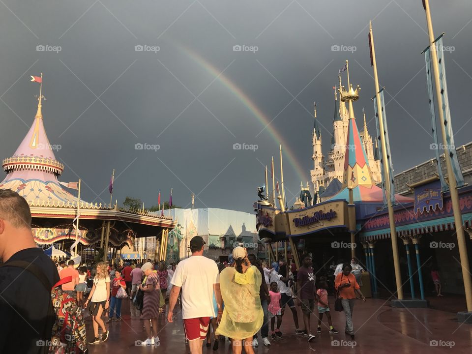 A rainbow ends at Cinderella's castle in Disney's Magic Kingdom in Orlando Florida  