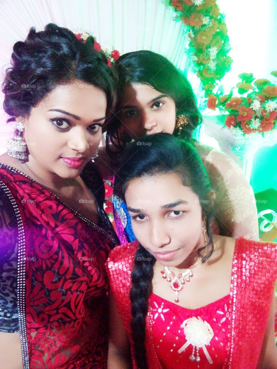beautiful asian girls with colourful dresses in a wedding function