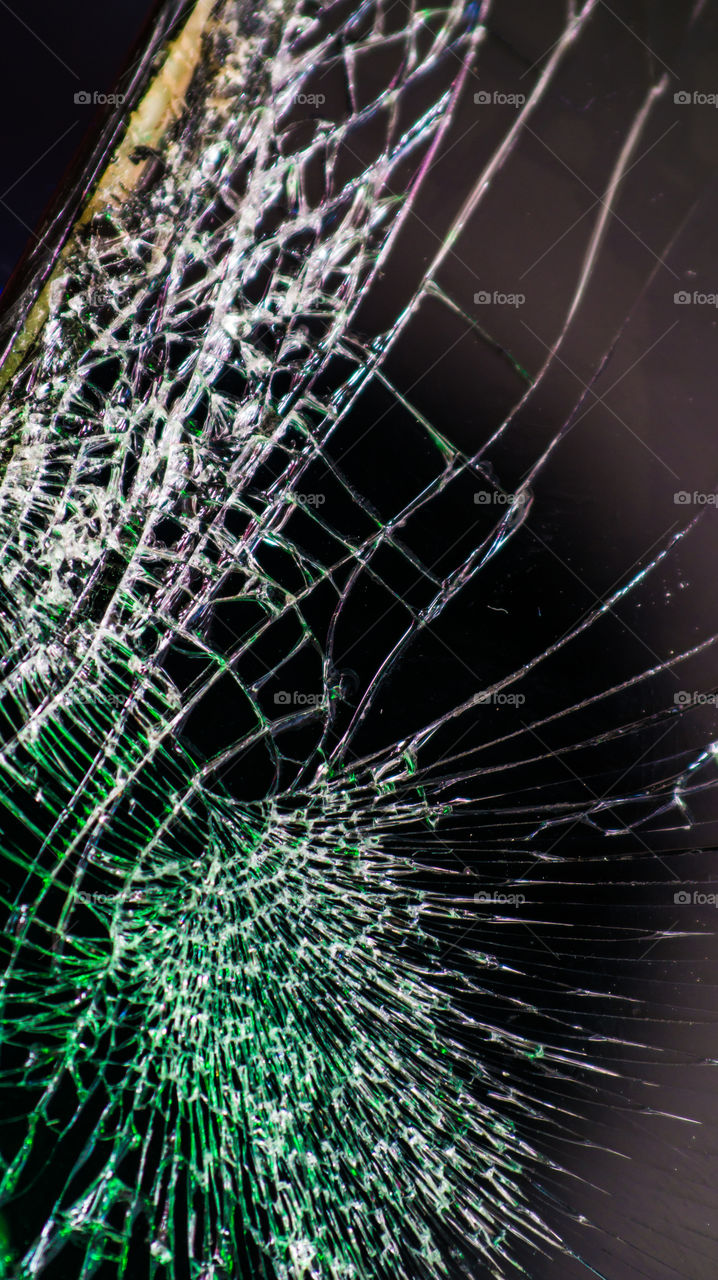 Multi-colored and bright broken smartphone screen close-up.