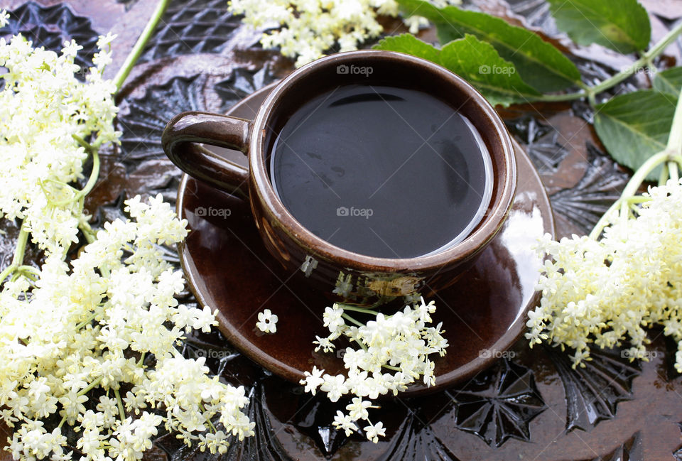 Summer morning, coffee on the wood-carved table