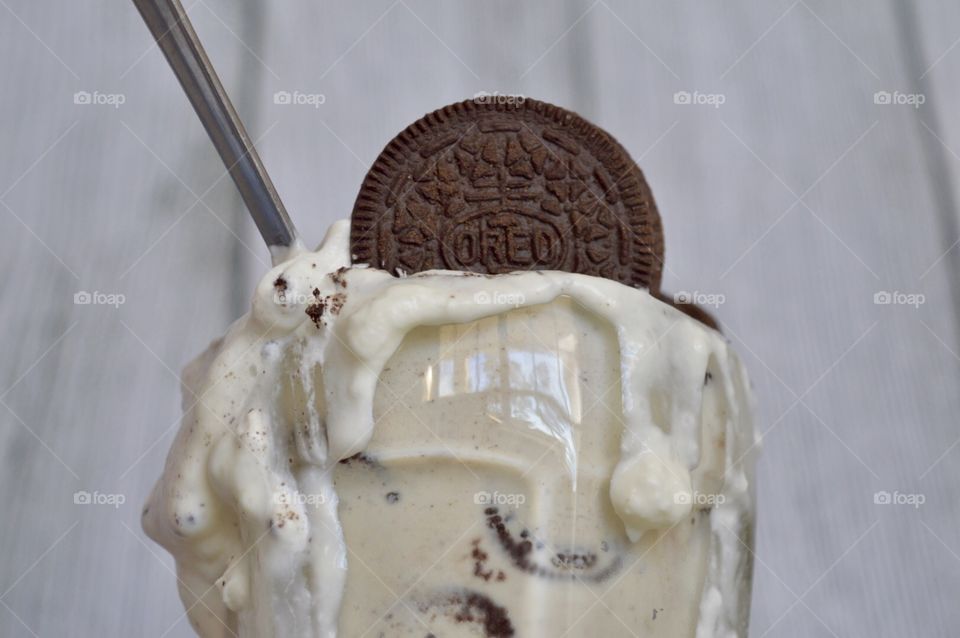 Oreo cookie milkshake with a wooden rustic white background
