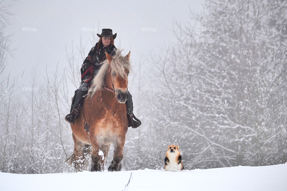 Woman ridding on horse in winter