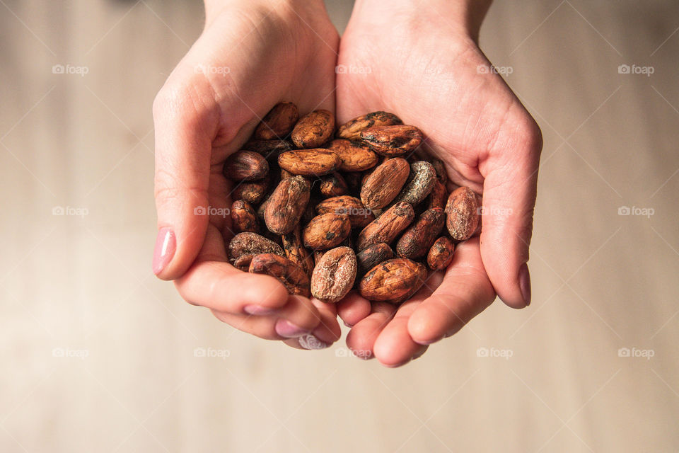 Hands holding coffee beans