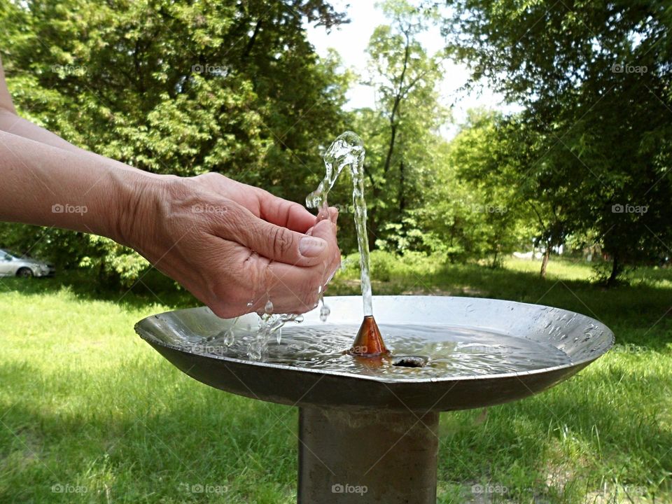 in the hands of a girl running water