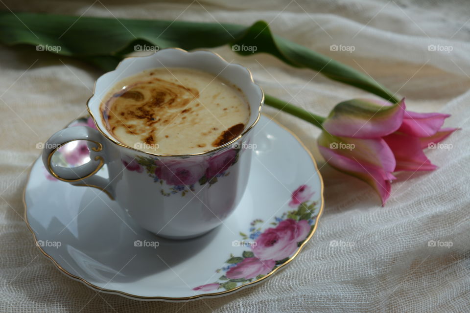 coffee cup with flower on table
