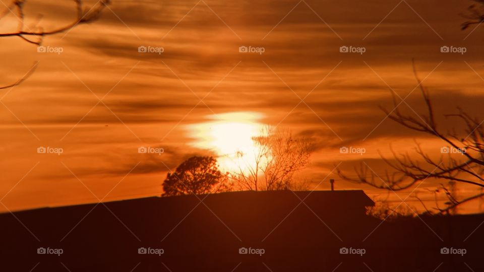 Sun beams spreading with the clouds presence. Dark backlit clouds preparing for Sundown. Beautiful colors represented well for Sunset.