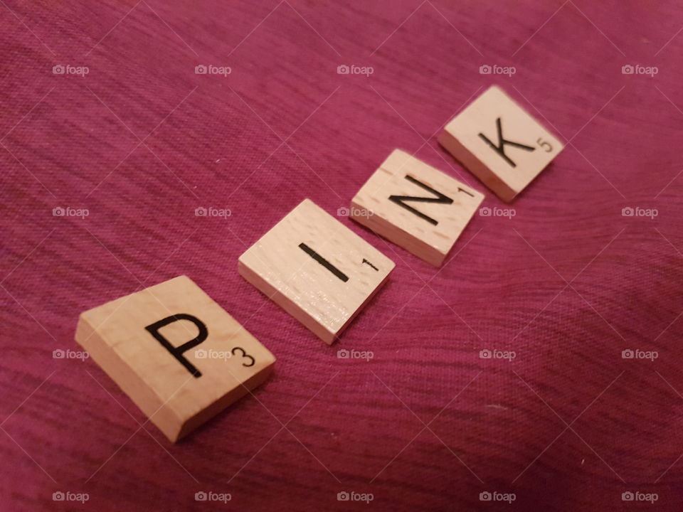 pink scrabble letters spell