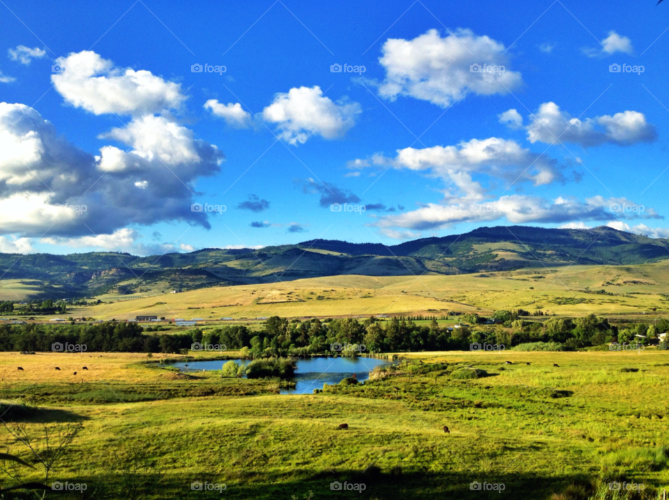 pasture clouds lake country by brahamd
