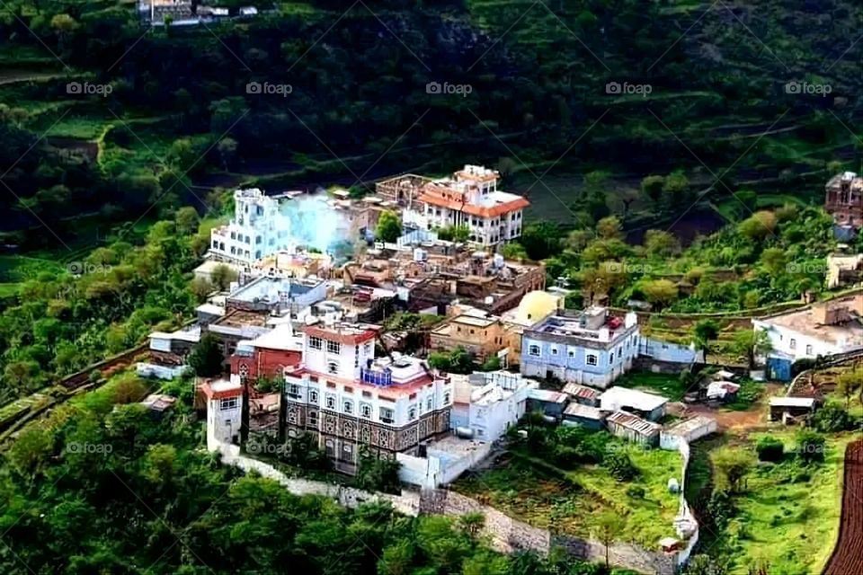 A stunning view of green mountains covered in fog in Yemen