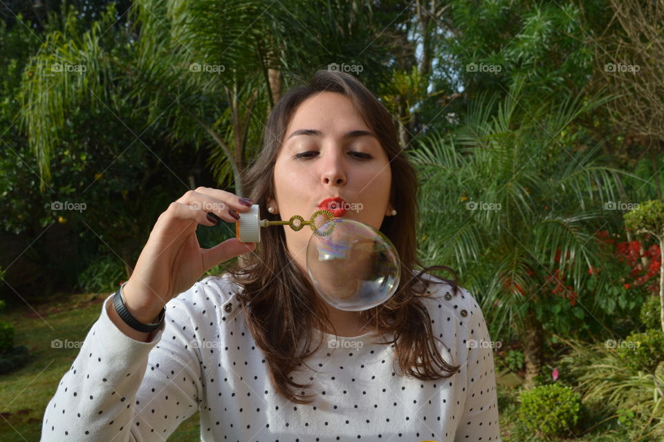 Beautiful girl blowing bubbles