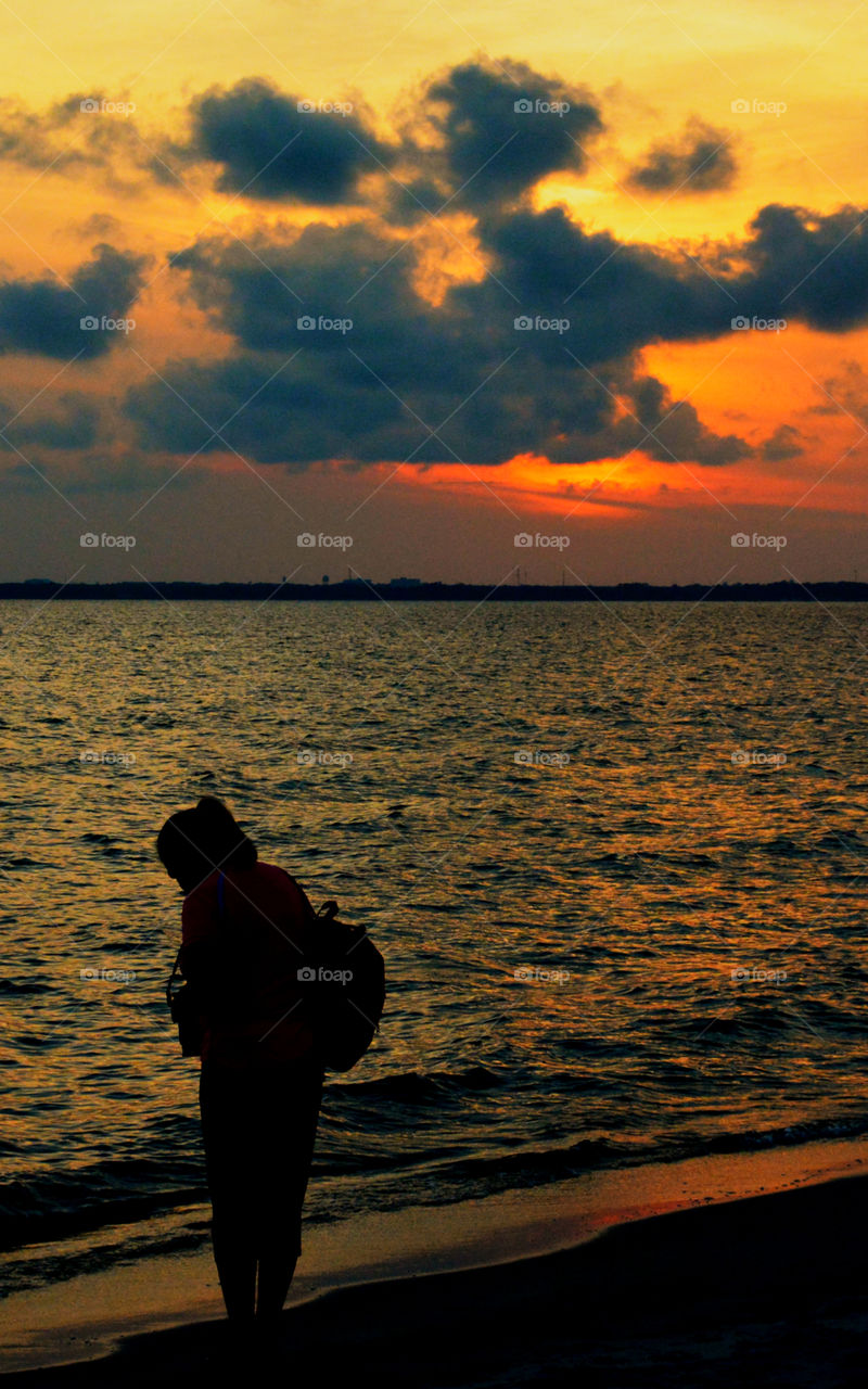 The sky was filled with the most brilliant orange complimented perfectly with hues of gold, yellow, red and crimson. An orange haze had casted over the water, reflecting off every wave. Finally,the sun disappears along with the shine. I can only wait to see another magical moment of beauty and warmth! I can only wait for another sunset! Enjoy!