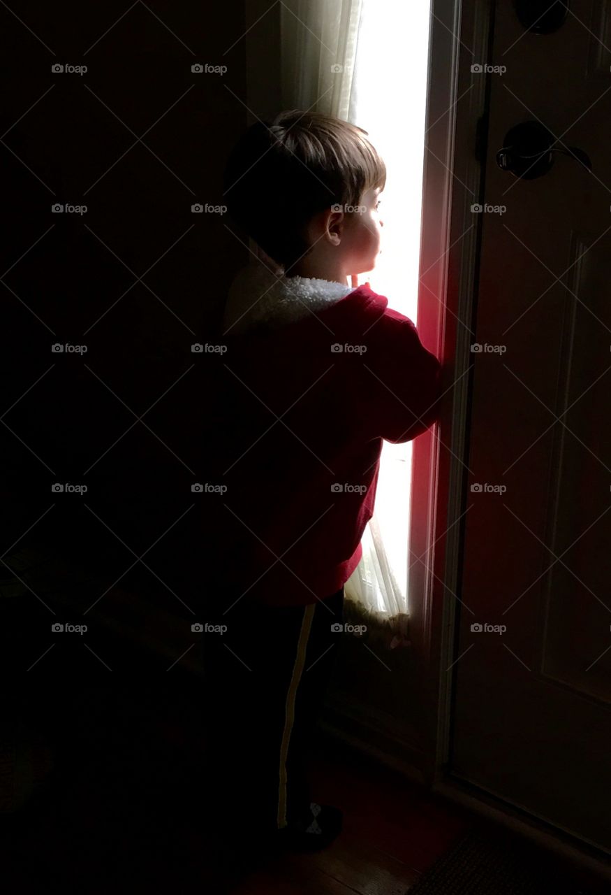 Child looking out window.