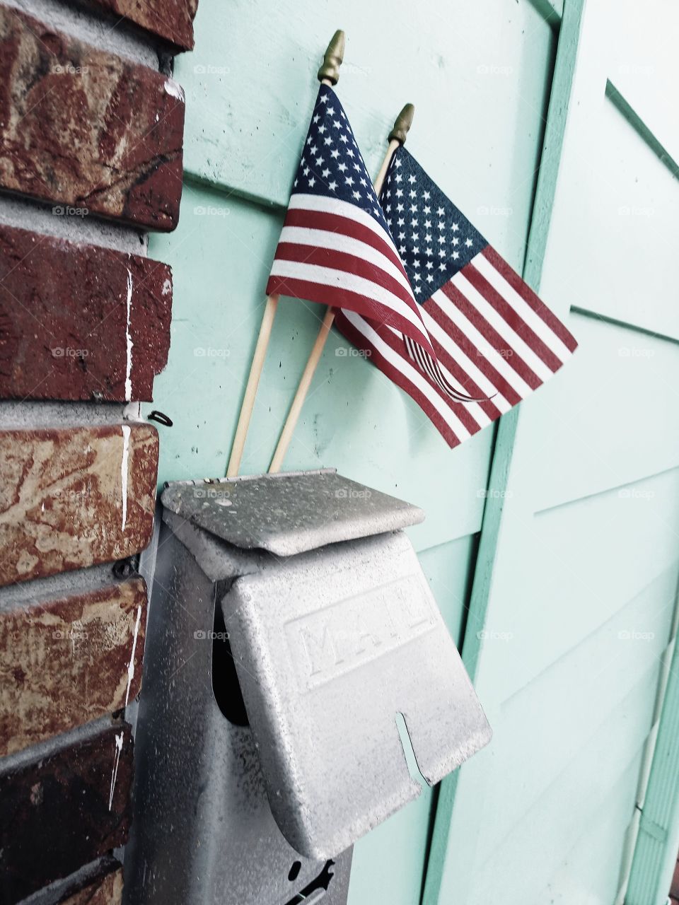 hand held American flags attached to mailbox